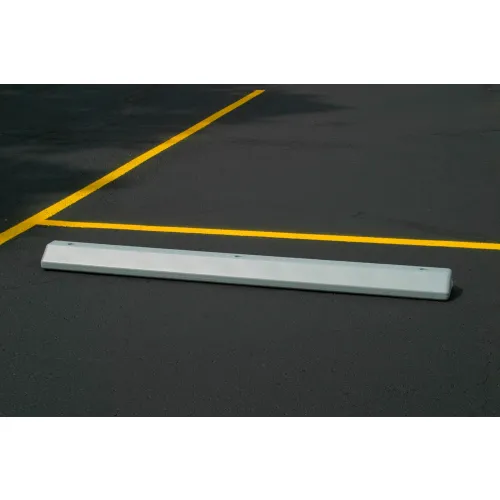 White parking wheel stop between yellow lines