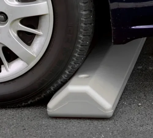 Car tire on plastic parking wheel stop
