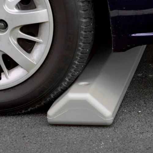 Car tire on plastic parking wheel stop
