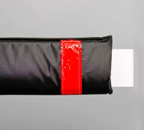 Black protective sleeve with red tape, white tab