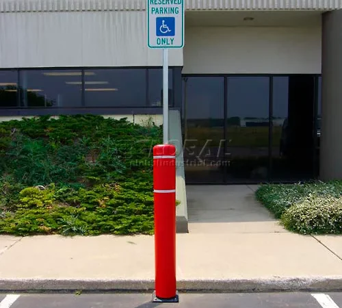 Reserved handicapped parking sign with red bollard
