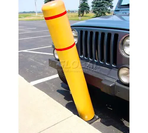 Yellow bollard leaning against parked vehicle bumper