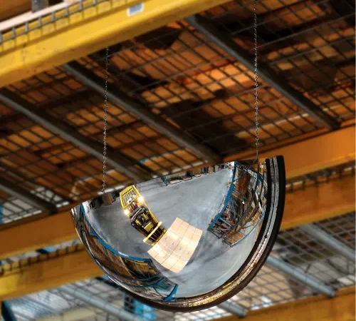Convex safety mirror reflecting warehouse forklift
