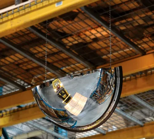 Hanging convex mirror reflecting forklift in warehouse