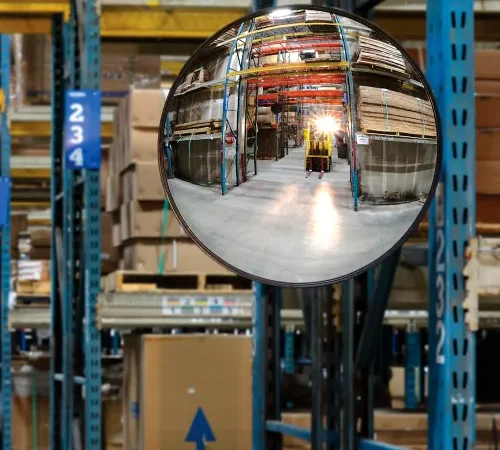 Convex mirror reflecting forklift in warehouse