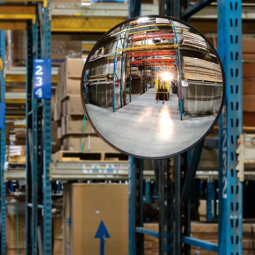 Convex mirror reflecting forklift in warehouse