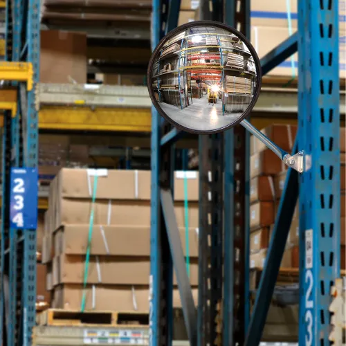 Convex safety mirror reflecting warehouse racks and forklift
