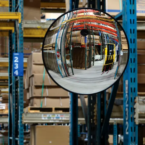 Convex safety mirror reflecting warehouse storage racks