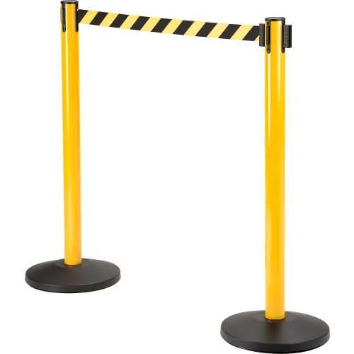 Yellow crowd-control stanchions with striped retractable belt