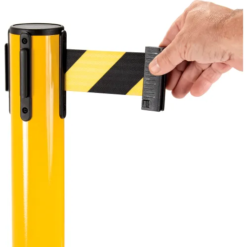 Hand pulling yellow striped retractable belt