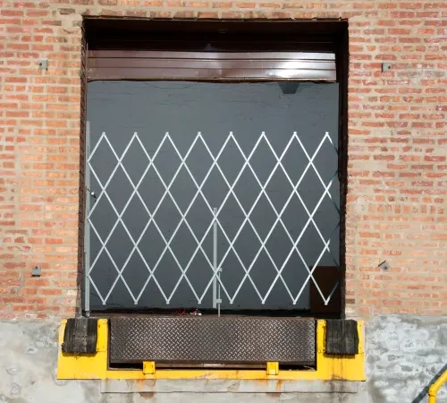 Loading dock door with diamond pattern security gate