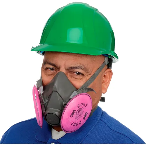 Worker wearing green hard hat and respirator