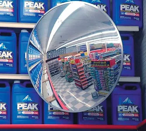 Convex mirror reflecting supermarket aisle and products