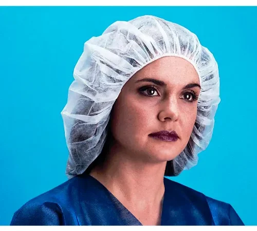 Woman wearing hairnet and medical scrubs
