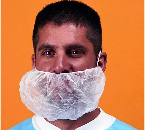 Person wearing disposable beard net and gown