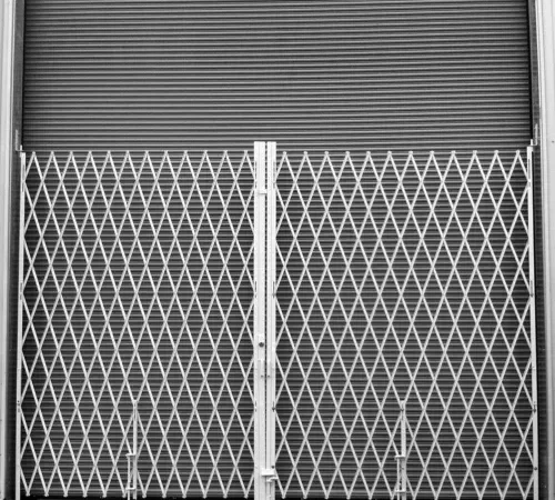 Closed accordion security gate with rolling shutter