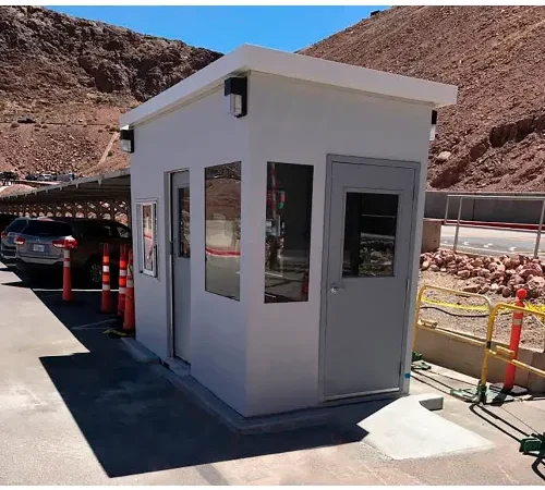 Small white security booth at parking entrance