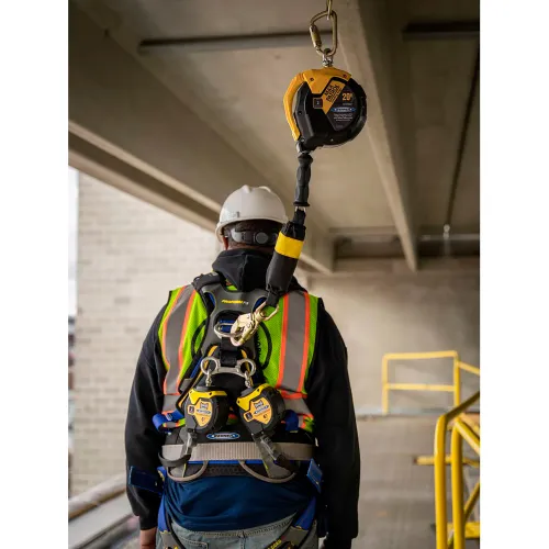 Construction worker wearing safety harness attached to lifeline