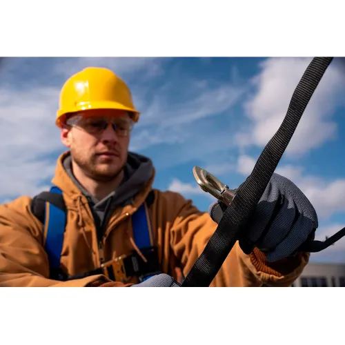 Construction worker securing safety harness with carabiner