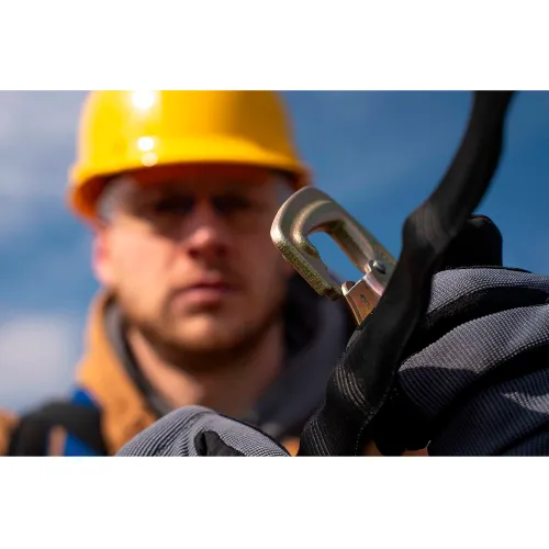 Construction worker fastening safety harness carabiner