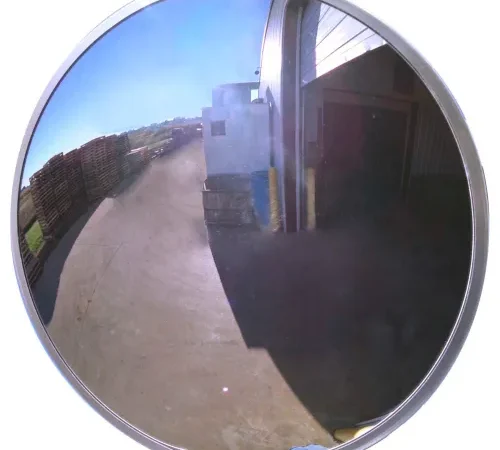 Convex safety mirror reflecting warehouse loading dock