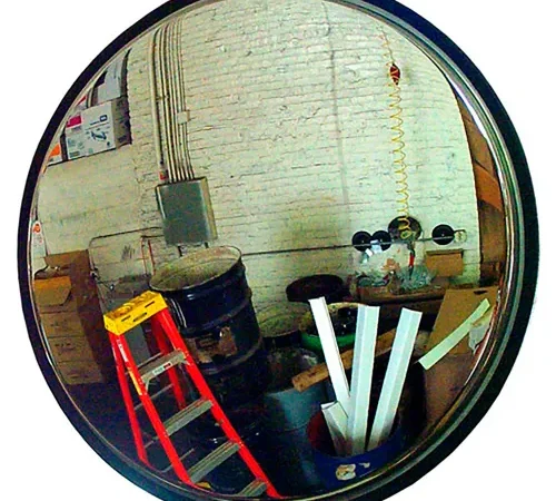 Convex mirror reflecting cluttered workshop with ladder