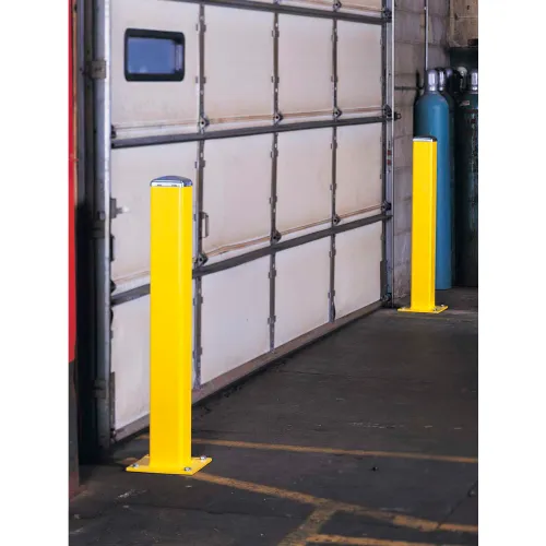 Two yellow bollards protecting garage door