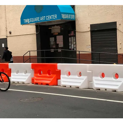 Orange and white plastic barriers outside art center